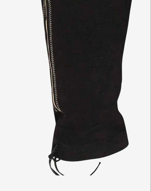 Side view of authentic alpine bundhosen highlighting leg seam detail, contrast stitching and traditional Bavarian knee tie finish