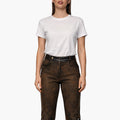 Woman wearing a white t-shirt and brown leather pants on a white background