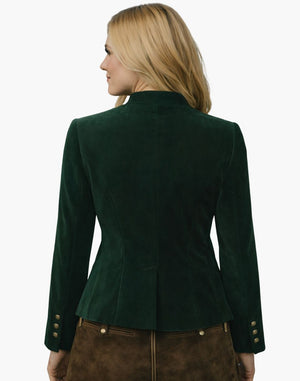 Back view of a woman wearing an authentic alpine green velvet Trachten jacket with a fitted waist and traditional Bavarian tailoring, paired with brown lederhosen, against a white background.