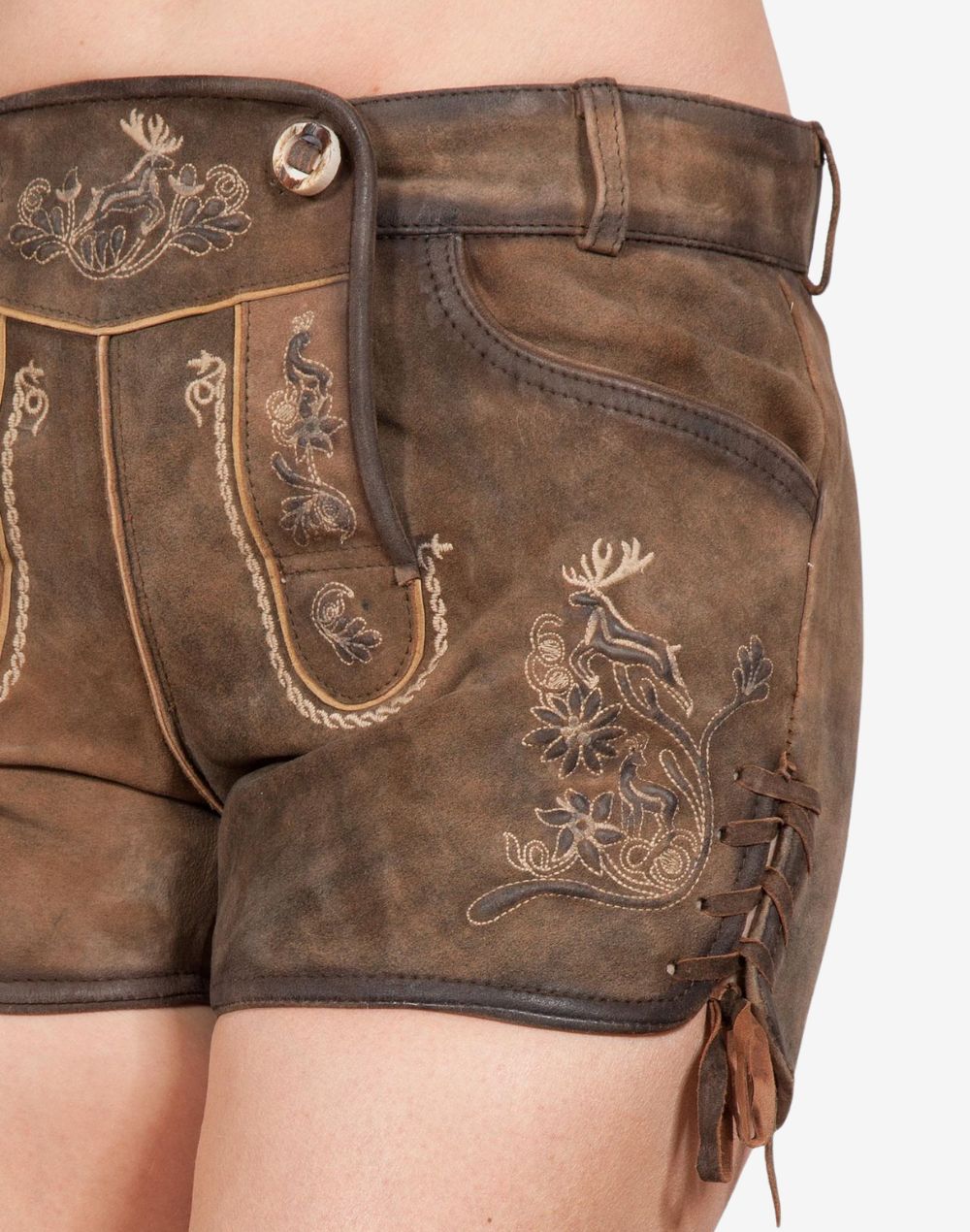 Close-up of brown women’s Bavarian lederhosen made of leather, featuring traditional embroidered deer and floral patterns, front flap closure, and side lace-up detailing.