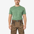 Model wearing authentic alpine lederhosen for men in brown leather with traditional Bavarian embroidery and belt buckle