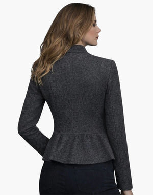 Woman wearing a gray peplum jacket on a white background