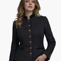 Female model in dark grey authentic Bavarian Trachten jacket featuring green trim, traditional buttons, and tailored fit on a white background.