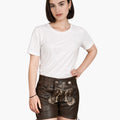 Woman wearing a white t-shirt and brown leather shorts with decorative elements on a white background