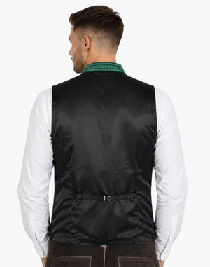 Back view of a men's black Trachten vest with an adjustable back buckle, green embroidered standing collar, and white shirt, paired with brown Lederhosen. Ideal for Oktoberfest and traditional Bavarian attire.