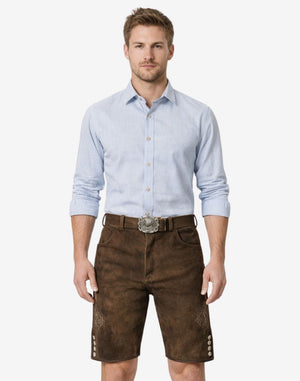 Model wearing authentic mens Bavarian lederhosen in dark brown leather with traditional embroidery and Oktoberfest belt buckle