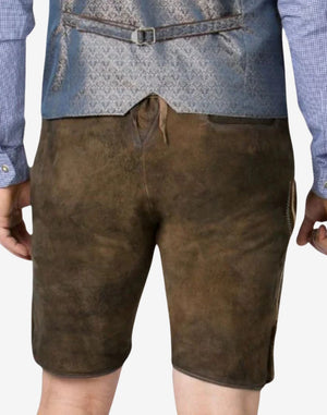 Classic Bavarian lederhosen in dark brown suede, showing detailed stitching, leg button closures, and a traditional belt.