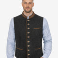 Model wearing authentic Oktoberfest vest for men with dark wool fabric and traditional Bavarian festival styling.