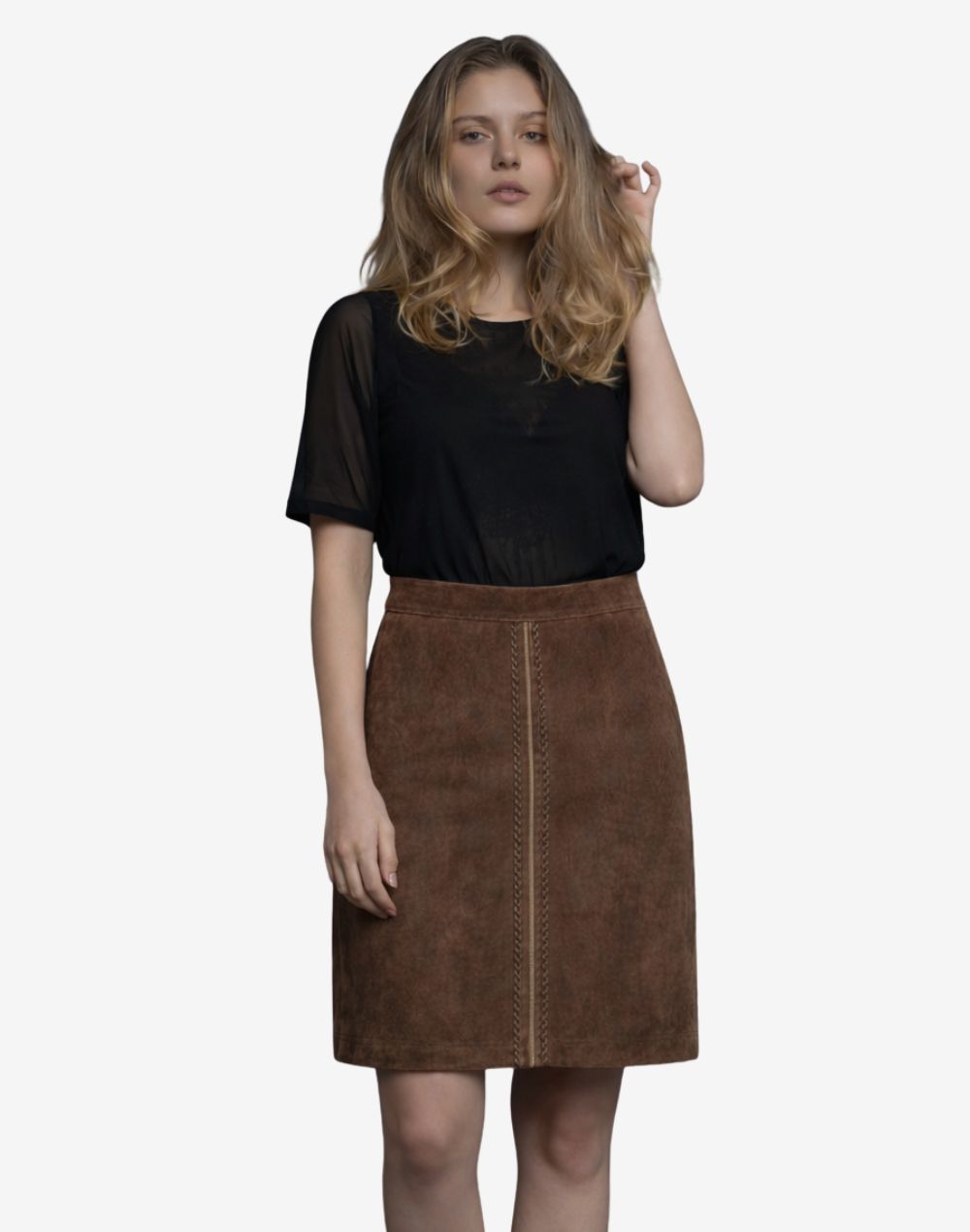 Front view of women's brown traditional Trachten skirt with high-waisted A-line silhouette and decorative braided front seam detail, paired with a sheer black short-sleeve top.