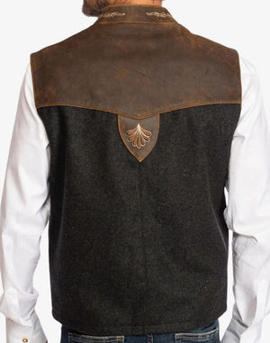 Black vest with brown leather accents worn over a white shirt on a plain background