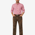 Man wearing a pink checkered shirt and brown pants on a white background