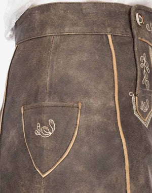 Close-up of women’s brown suede Bavarian-style leather skirt featuring decorative stitching, embroidered side pocket detail, and traditional trachten design.