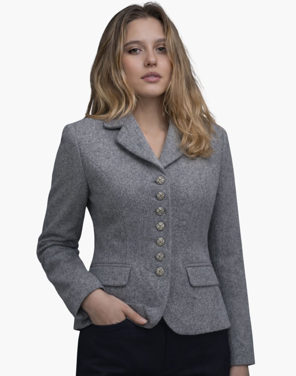 Front view of a woman wearing a light gray tailored jacket with a notched collar and a vertical row of decorative silver-tone buttons down the front. The fitted jacket features flap pockets at the waist and shaping seams for a defined silhouette, paired with dark trousers. The background is plain light gray.