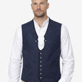 Model wearing mens traditional blue alpine wool waistcoat paired with shirt and lederhosen, highlighting classic Bavarian styling, premium wool fabric and authentic Oktoberfest outfit look.