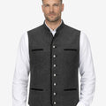 Model wearing charcoal grey German vest paired with white shirt and traditional lederhosen, highlighting refined wool texture, authentic Trachten design and elegant Oktoberfest outfit styling.