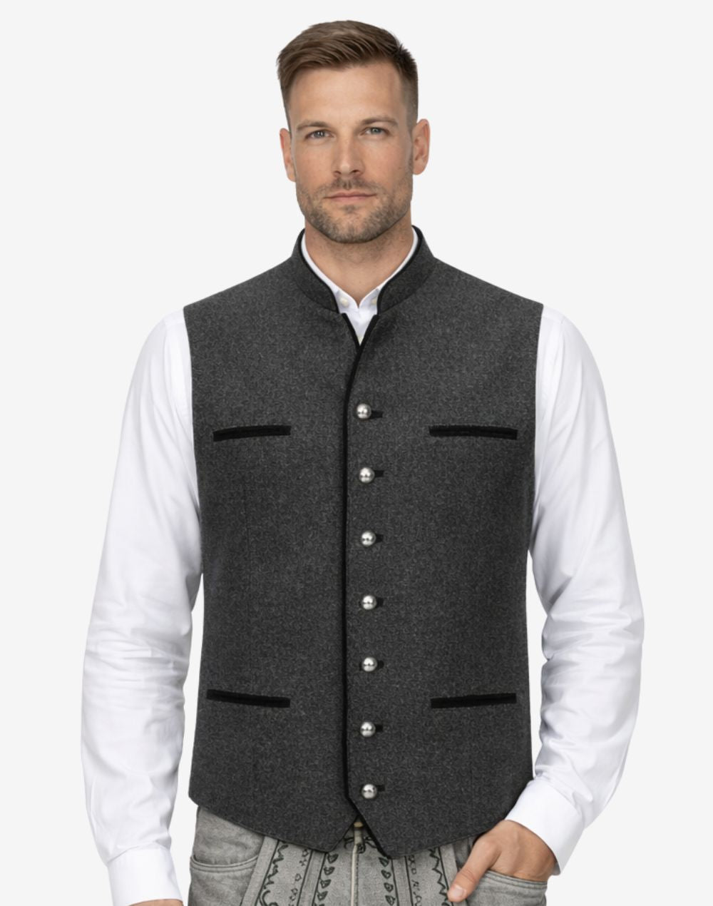 Model wearing charcoal grey German vest paired with white shirt and traditional lederhosen, highlighting refined wool texture, authentic Trachten design and elegant Oktoberfest outfit styling.
