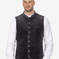 Model wearing charcoal velvet Bavarian vest for men paired with white shirt and lederhosen showcasing authentic Oktoberfest style.