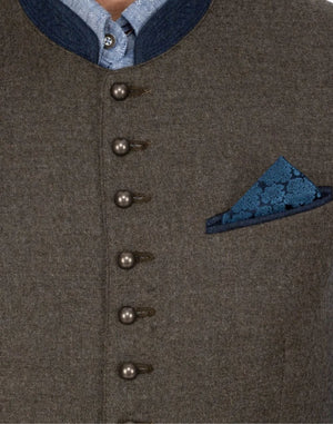 Detailed close-up of Classic Alpine Trachten vest featuring traditional Bavarian metal buttons, blue pocket square and textured wool fabric design.