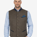 Male model wearing Classic Alpine Trachten vest paired with Bavarian shirt and traditional Lederhosen outfit styled for Oktoberfest festivals and German heritage clothing.