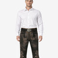 Front view of model wearing classic Bavarian Bundhosen shorts in dark leather with traditional embroidery and Oktoberfest knee tie details