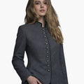 Woman wearing a gray blazer with button details on a white background