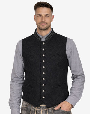 Male model wearing classic black wool Bavarian vest paired with traditional attire, ideal for Oktoberfest and formal Alpine occasions.