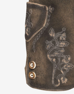 Close-up of brown leather women’s lederhosen showing embroidered floral detailing near the side pocket and decorative side buttons on a distressed leather finish.