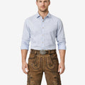 Model wearing classic German lederhosen for men in brown leather with embroidered Bavarian details and traditional Oktoberfest belt