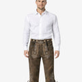 Front view of model wearing Classic Oktoberfest Bundhosen Men in brown leather with traditional Bavarian embroidery and knee tie details