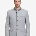 Model wearing classic silver grey Bavarian jacket for men with stand collar, elegant button front, traditional German design, paired with lederhosen for Oktoberfest outfit.