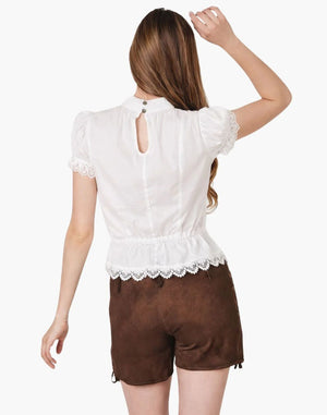 Woman wearing a white lace-trimmed top and brown shorts on a white background