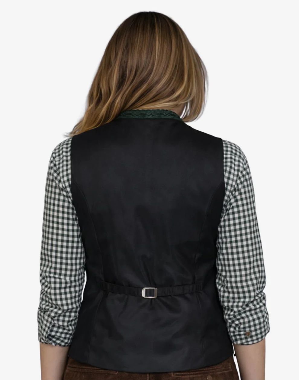 Person wearing a black vest over a checkered shirt on a white background