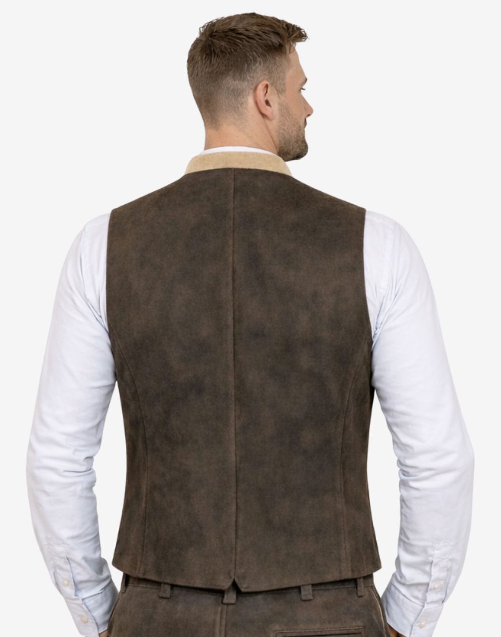 Rear view of model wearing dark brown suede Trachten vest highlighting fitted cut and traditional Bavarian design.