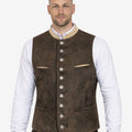 Model wearing dark brown suede Bavarian Trachten vest paired with white shirt and lederhosen for Oktoberfest outfit.