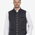 Model wearing dark grey wool Alpine vest for men paired with traditional Bavarian outfit, perfect for Oktoberfest and cultural events.