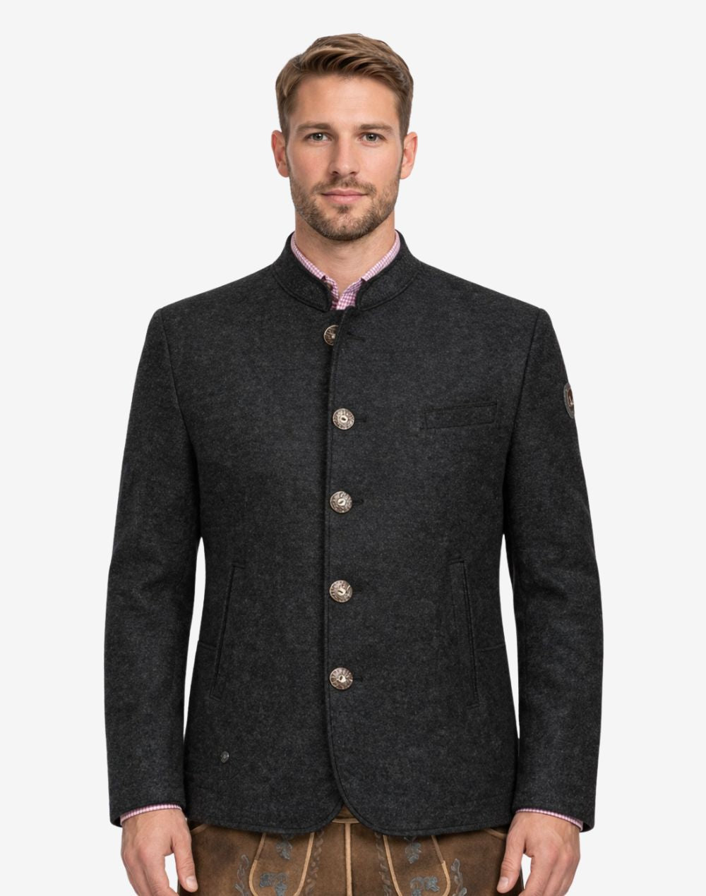 Model wearing deep rustic charcoal Trachten jacket for men with stand collar, traditional Bavarian style, button front, and paired with lederhosen for Oktoberfest outfit.