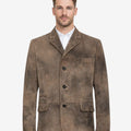 Model wearing distressed suede men’s Trachten coat with vintage brown finish, classic Bavarian style, button front closure, and traditional Oktoberfest look.