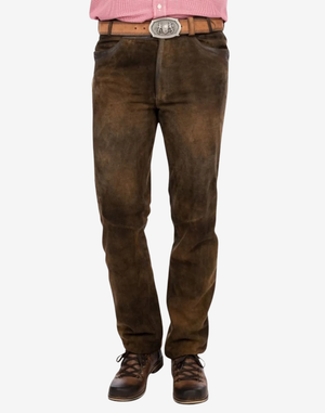 Brown jeans worn with a pink shirt and brown shoes on a white background