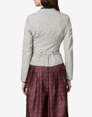 Back view of a women’s light grey traditional Bavarian trachten jacket with tailored fit and pleated waist detail, worn over a patterned burgundy dirndl skirt.