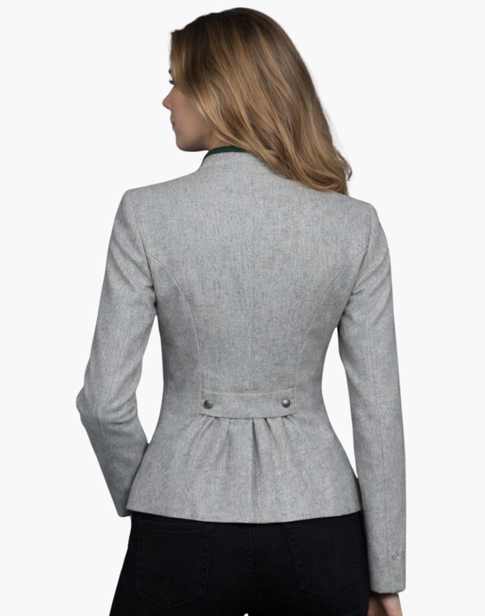 Back view of a woman wearing a fitted light gray wool jacket with structured seams and a peplum-style hem. The jacket features a decorative back tab with two buttons at the waist and soft gathers below it. She pairs it with dark jeans, and her shoulder-length blonde hair falls over a green-trimmed collar. The background is plain light gray in a studio setting.