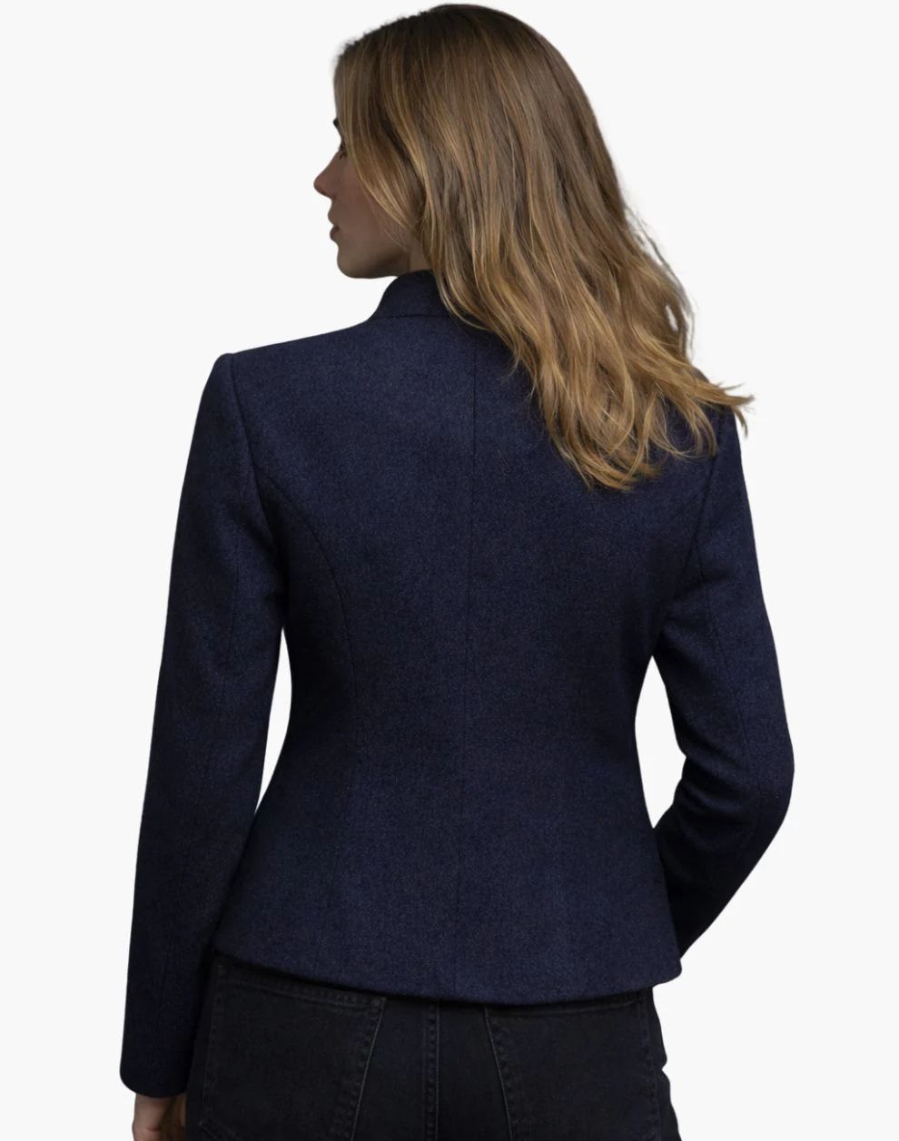 Woman wearing a navy blue blazer on a white background