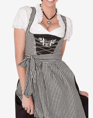 Model wearing festival ready dirndl dress with green apron, fitted bodice and authentic Oktoberfest alpine look