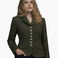 Front view of a woman wearing an olive green tailored jacket with a notched collar and a vertical row of decorative silver-tone buttons down the front. The fitted jacket features flap pockets at the waist and structured seams that contour the silhouette, paired with dark trousers. The background is plain light gray in a clean studio setting.