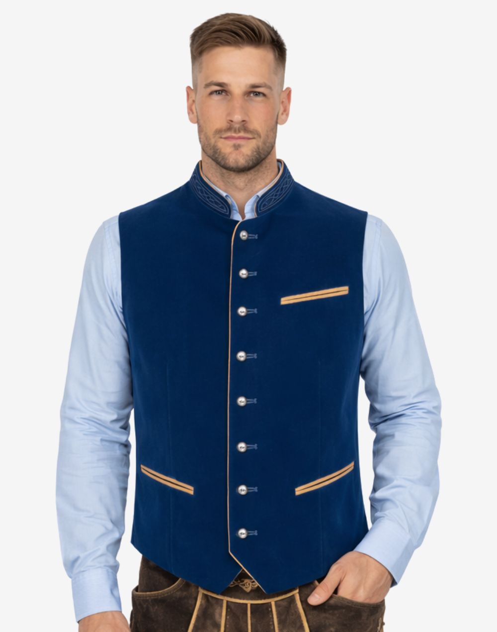 Male model wearing festival ready Trachten vest in deep blue velvet paired with Bavarian shirt and traditional Lederhosen Oktoberfest outfit