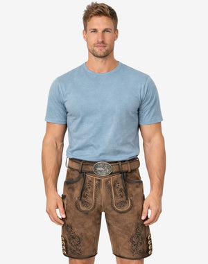 Model wearing forest scene suede lederhosen for men with Bavarian embroidery and traditional Oktoberfest style