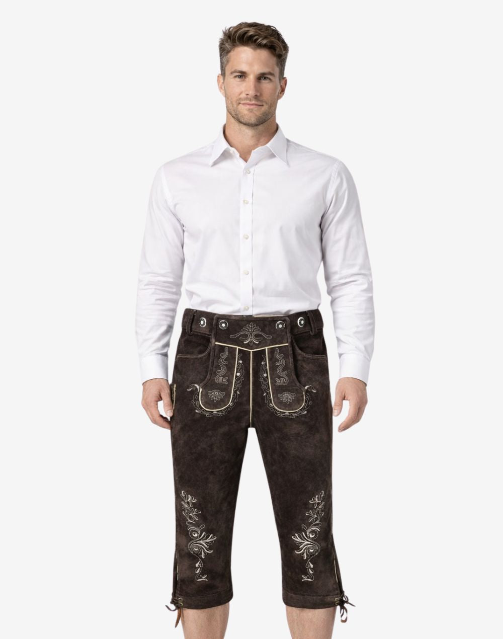Front view of model wearing genuine leather Bundhosen for men in dark brown with traditional Bavarian embroidery and knee tie detailing for Oktoberfest attire