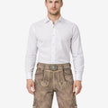 Model wearing genuine leather lederhosen for men in traditional Bavarian style with decorative embroidery and belt buckle