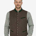 Front view of model wearing German Oktoberfest Vest for Men in brown tweed with green trim and metal buttons