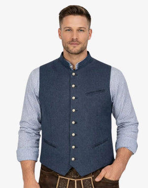 Man wearing a blue vest over a checkered shirt on a white background