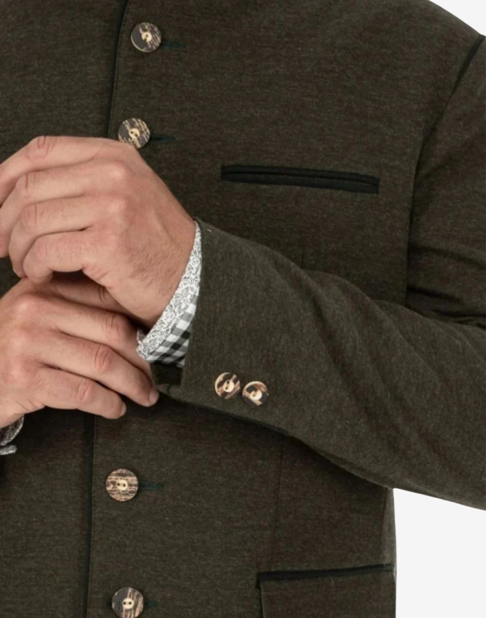 Close up of green wool Trachten jacket showing decorative side buttons and pocket trim with traditional Bavarian craftsmanship.